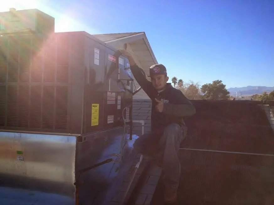HVAC technician performing Heat Pump Repair on a rooftop unit in Mount Washington